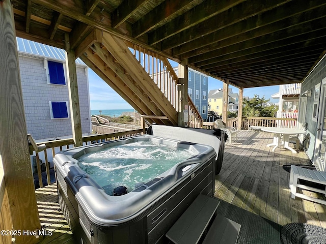 4388 Island Dr, North Topsail Beach, NC 28460 - wooden deck featuring a hot tub, stairs, and a water view