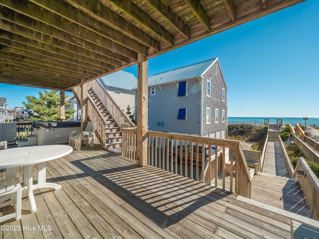 4388 Island Dr, North Topsail Beach, NC 28460 - deck featuring a hot tub, stairway, and a water view