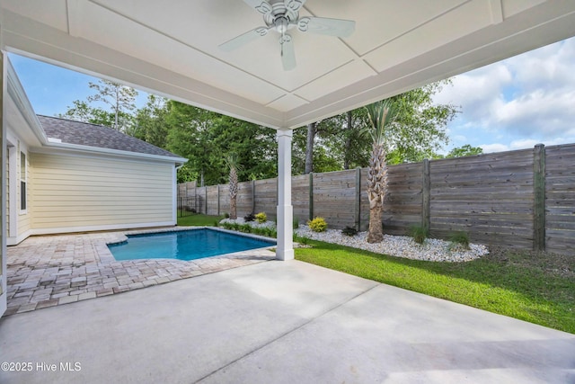 view of pool with ceiling fan, a patio, and a fenced backyard