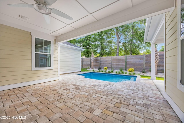 view of swimming pool featuring a ceiling fan, a patio area, and a fenced backyard