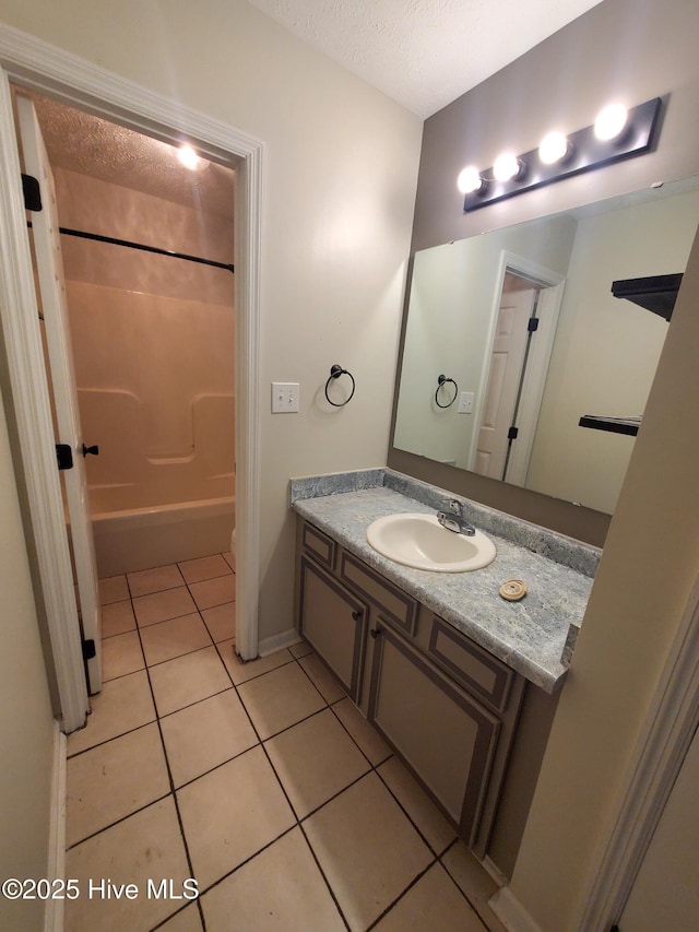 bathroom featuring tile patterned floors, vanity, shower / washtub combination, and a textured ceiling