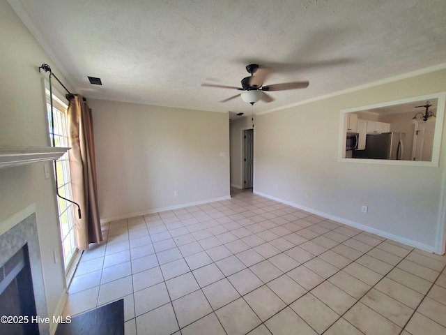 unfurnished living room with a ceiling fan, a textured ceiling, baseboards, light tile patterned floors, and a fireplace