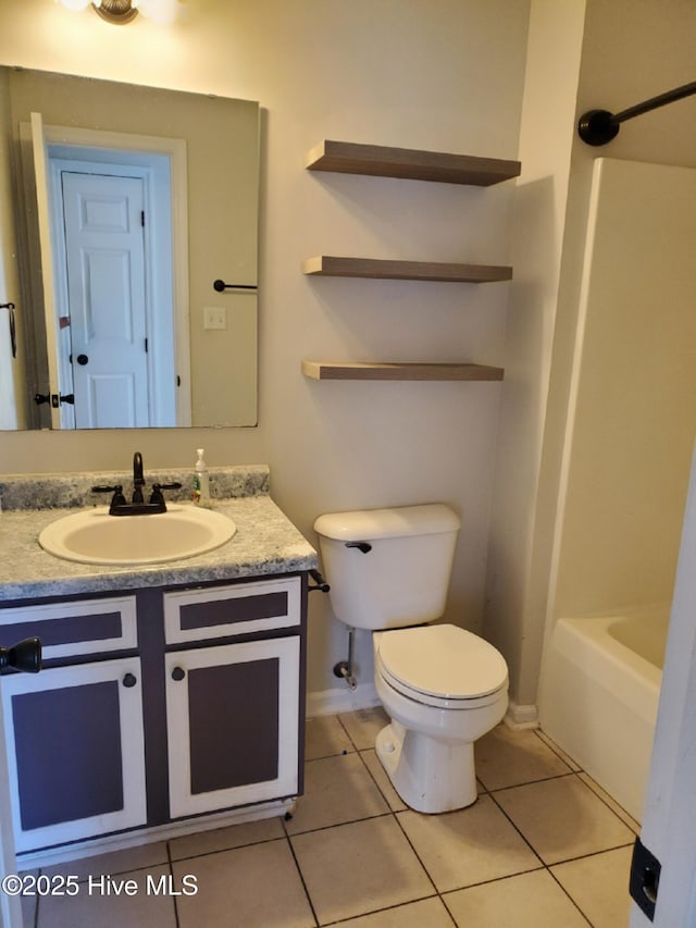 full bathroom with toilet, tile patterned flooring, vanity, and baseboards