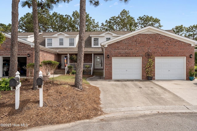 traditional-style house featuring concrete driveway, brick siding, a porch, and an attached garage