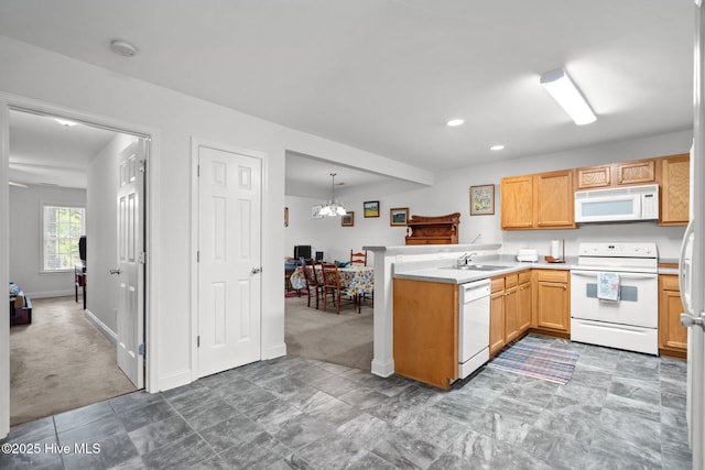 kitchen with white appliances, light colored carpet, a peninsula, light countertops, and recessed lighting