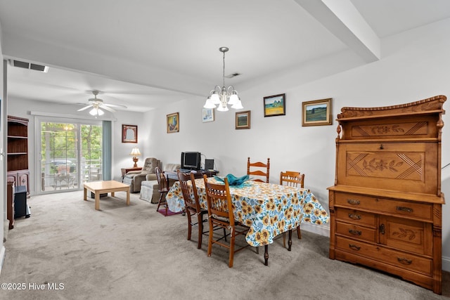 dining space with carpet flooring, a chandelier, and a ceiling fan