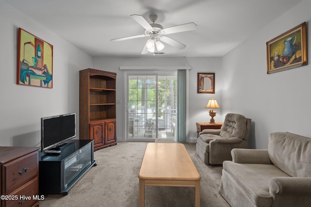 carpeted living area featuring ceiling fan