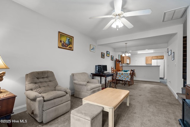 living room with carpet floors, ceiling fan, and baseboards