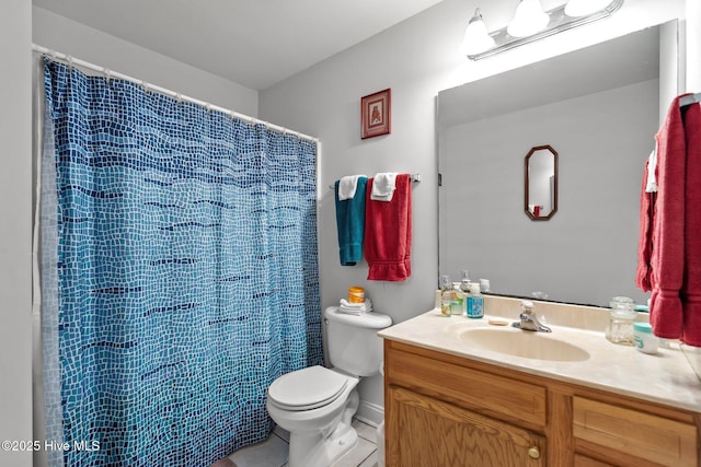 bathroom featuring toilet, tile patterned flooring, and vanity