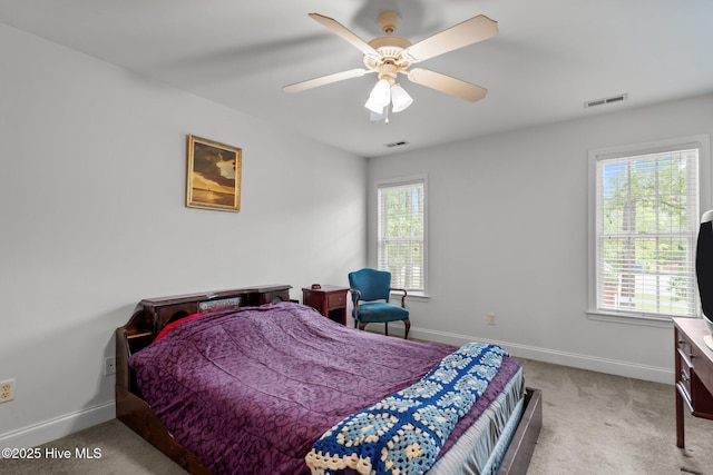 carpeted bedroom with baseboards and a ceiling fan