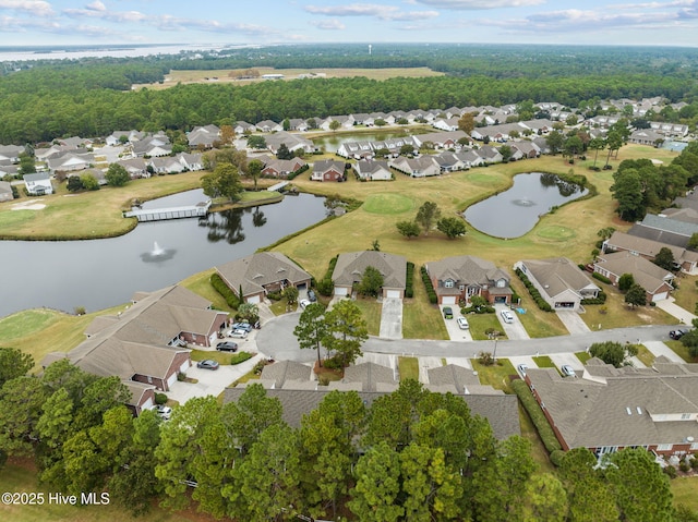 aerial view of property's location with nearby suburban area and a large body of water