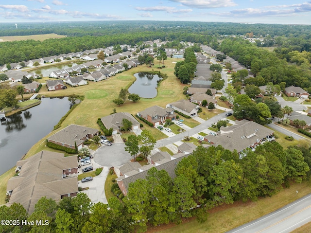 aerial view of property and surrounding area with nearby suburban area, a large body of water, and a golf club