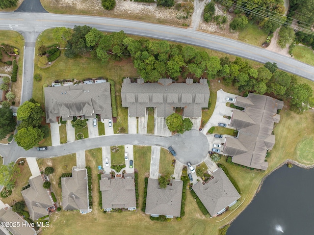 aerial overview of property's location with a nearby body of water and nearby suburban area