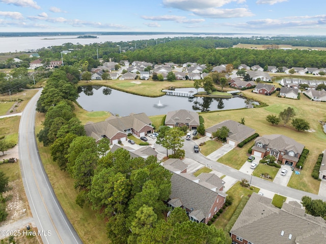 aerial view of property's location with nearby suburban area and a nearby body of water