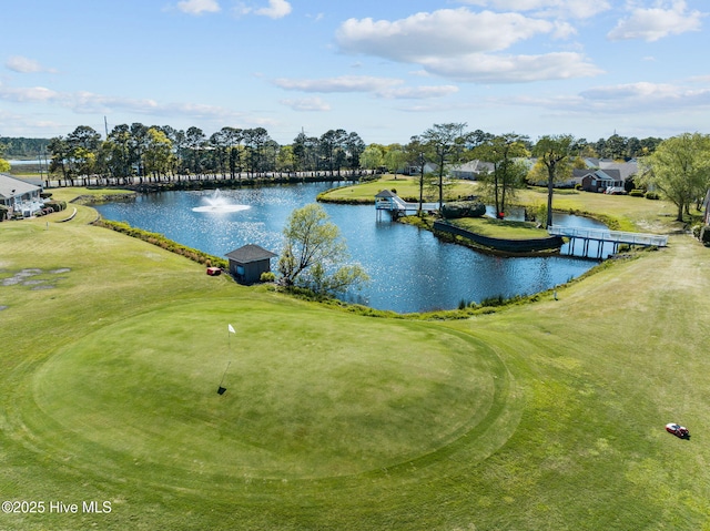water view with a golf club and a tree filled landscape
