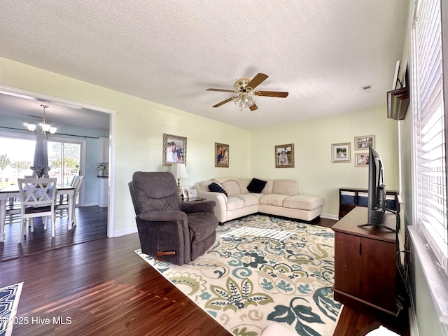 207 Rhonda Rd, Elizabeth City, NC 27909 - living room featuring dark wood-style flooring, ceiling fan, baseboards, a textured ceiling, and a chandelier