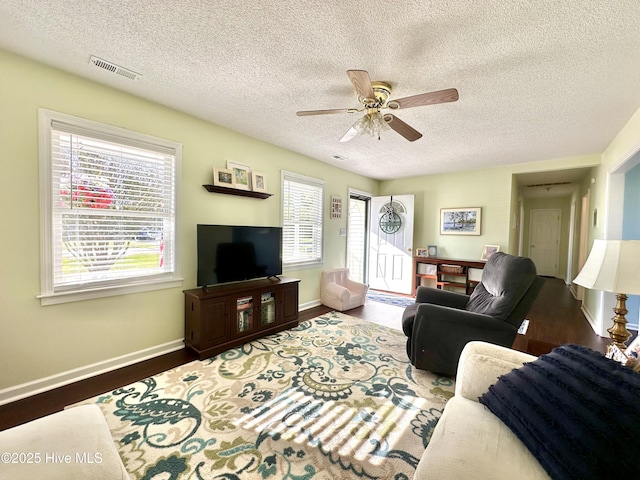 207 Rhonda Rd, Elizabeth City, NC 27909 - living area featuring a textured ceiling, baseboards, a ceiling fan, and wood finished floors