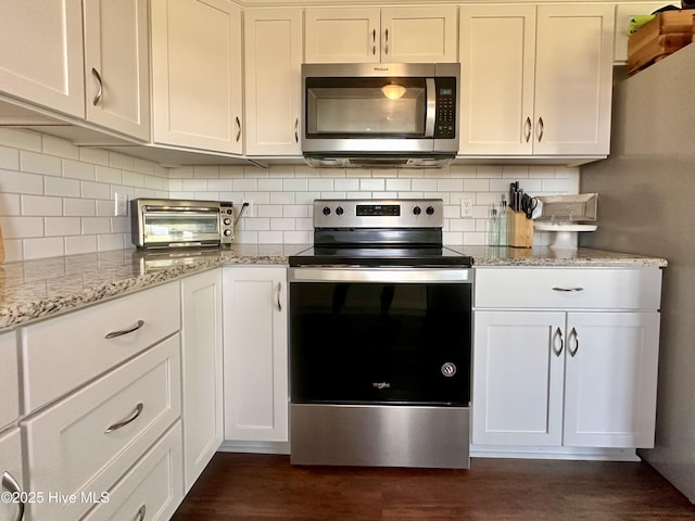 207 Rhonda Rd, Elizabeth City, NC 27909 - kitchen with stainless steel appliances, dark wood-style flooring, tasteful backsplash, and light stone counters