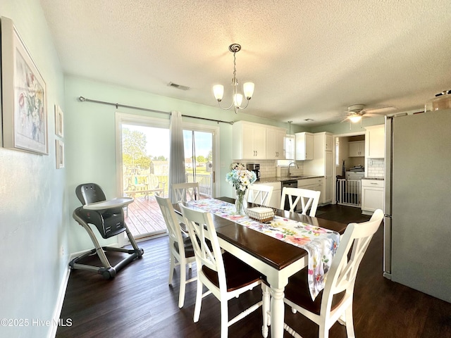 207 Rhonda Rd, Elizabeth City, NC 27909 - dining area with dark wood-style floors, a textured ceiling, a ceiling fan, a chandelier, and baseboards