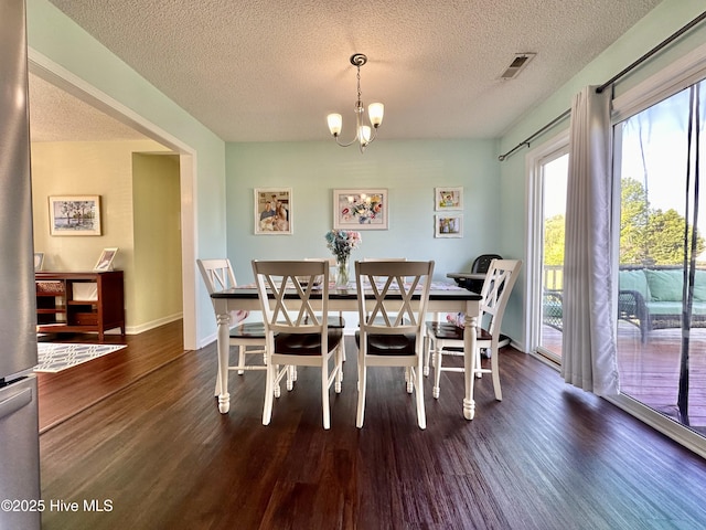 207 Rhonda Rd, Elizabeth City, NC 27909 - dining area featuring wood finished floors, a textured ceiling, a chandelier, and baseboards