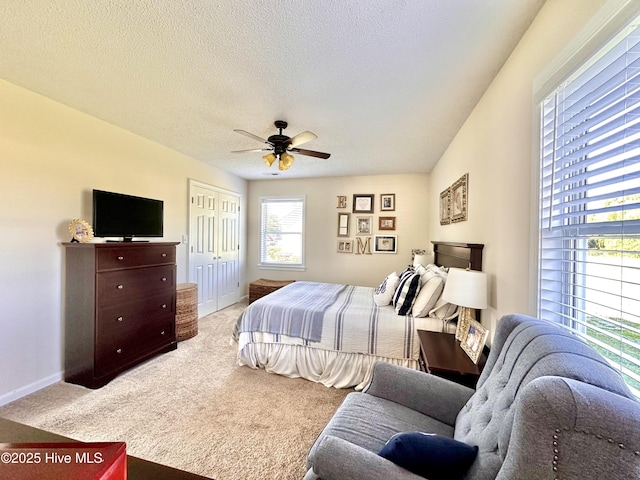 207 Rhonda Rd, Elizabeth City, NC 27909 - carpeted bedroom with a closet, baseboards, ceiling fan, and a textured ceiling
