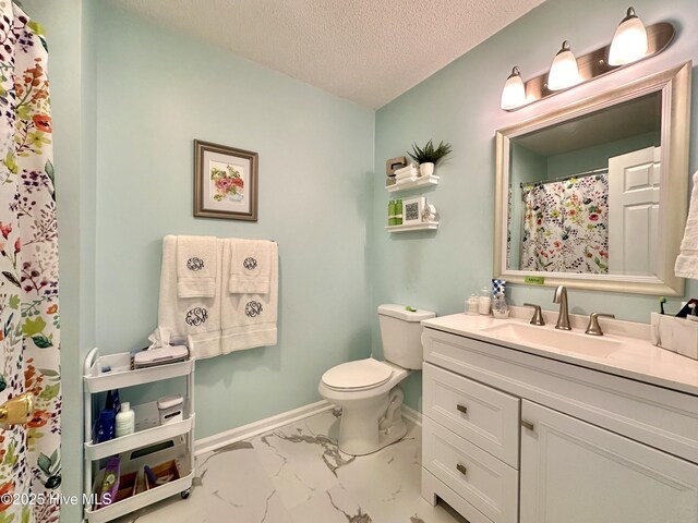 207 Rhonda Rd, Elizabeth City, NC 27909 - bathroom featuring marble finish floors, toilet, vanity, a textured ceiling, and baseboards