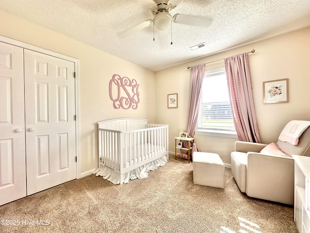207 Rhonda Rd, Elizabeth City, NC 27909 - carpeted bedroom with a nursery area, a textured ceiling, a ceiling fan, a closet, and baseboards