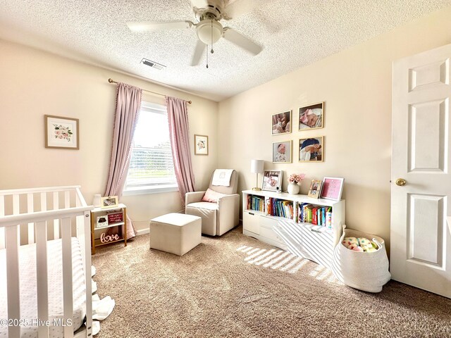 207 Rhonda Rd, Elizabeth City, NC 27909 - carpeted bedroom with a textured ceiling, a crib, and a ceiling fan