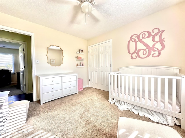207 Rhonda Rd, Elizabeth City, NC 27909 - bedroom with a closet, carpet, a nursery area, a textured ceiling, and ceiling fan