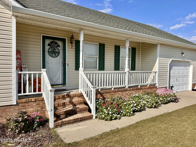 207 Rhonda Rd, Elizabeth City, NC 27909 - property entrance with a porch, roof with shingles, a garage, and driveway