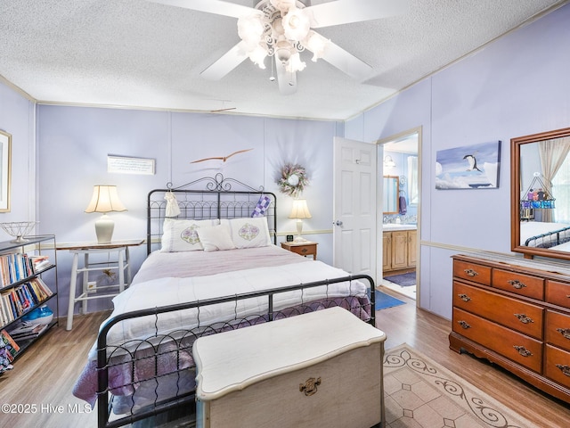 366 Ampersand Rd, Aberdeen, NC 28315 - bedroom with light wood-type flooring, a textured ceiling, ensuite bath, and ceiling fan