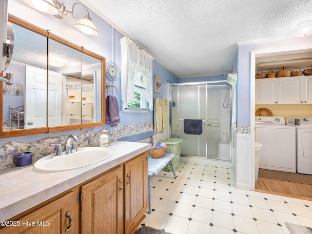 366 Ampersand Rd, Aberdeen, NC 28315 - bathroom with separate washer and dryer, tile patterned floors, a textured ceiling, a shower stall, and vanity