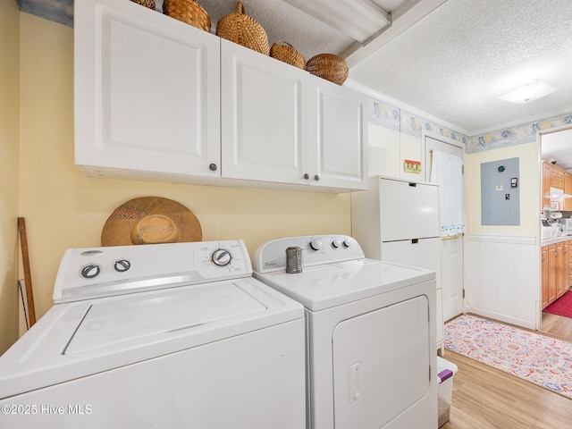 366 Ampersand Rd, Aberdeen, NC 28315 - laundry area featuring cabinet space, electric panel, independent washer and dryer, light wood finished floors, and a textured ceiling