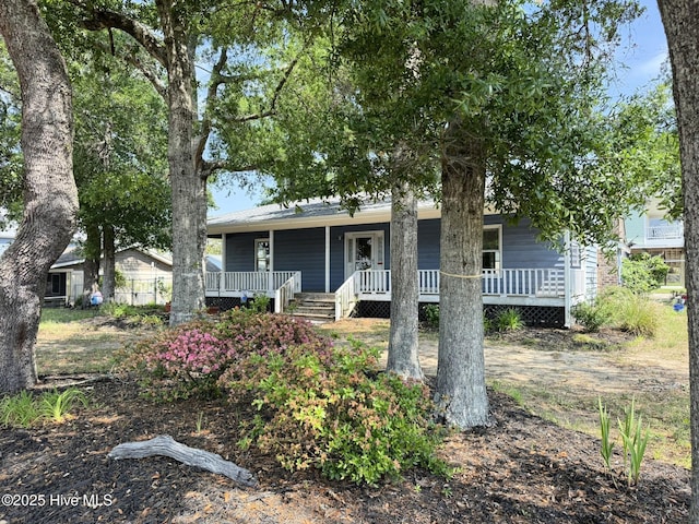 3306 E Oak Island Dr, Oak Island, NC 28465 - view of front facade featuring a porch