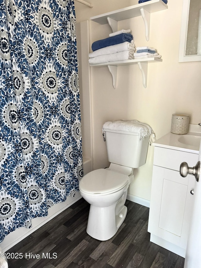 3306 E Oak Island Dr, Oak Island, NC 28465 - full bath featuring wood finished floors, toilet, vanity, and baseboards