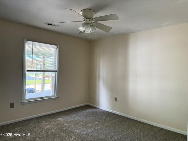 3306 E Oak Island Dr, Oak Island, NC 28465 - empty room with dark carpet, baseboards, and a ceiling fan