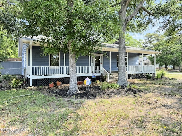 3306 E Oak Island Dr, Oak Island, NC 28465 - view of front of home featuring covered porch