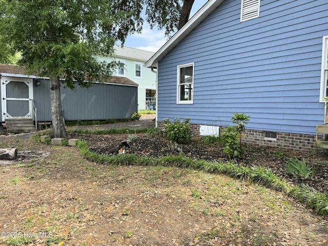 3306 E Oak Island Dr, Oak Island, NC 28465 - view of property exterior with a shed, an outdoor structure, and crawl space