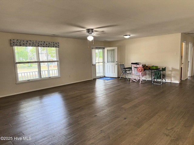 3306 E Oak Island Dr, Oak Island, NC 28465 - unfurnished living room featuring ceiling fan, dark wood-type flooring, and baseboards