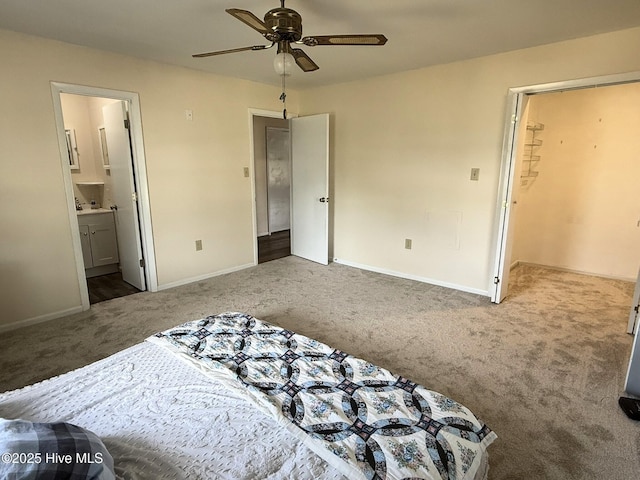 3306 E Oak Island Dr, Oak Island, NC 28465 - bedroom featuring carpet flooring, baseboards, connected bathroom, and a ceiling fan