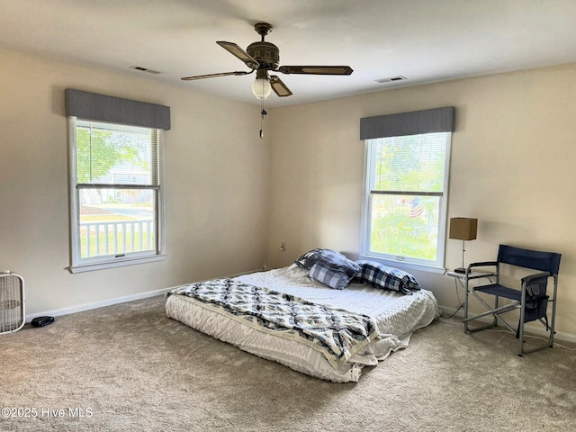 3306 E Oak Island Dr, Oak Island, NC 28465 - carpeted bedroom with baseboards and ceiling fan