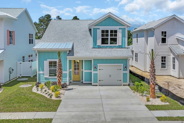 1961 Indigo Cove Way, Calabash, NC 28467 - view of front of house with board and batten siding, a garage, concrete driveway, and a shingled roof