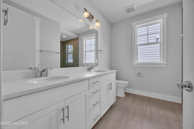 1961 Indigo Cove Way, Calabash, NC 28467 - full bath featuring a tile shower, baseboards, double vanity, and toilet