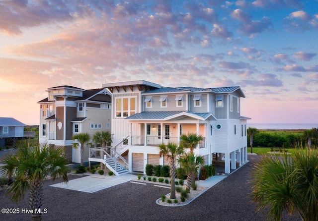 1961 Indigo Cove Way, Calabash, NC 28467 - view of front of home featuring a standing seam roof, metal roof, a porch, stairway, and board and batten siding
