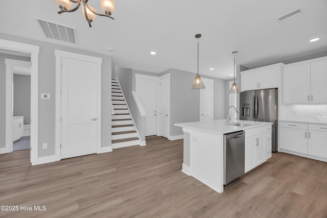 1961 Indigo Cove Way, Calabash, NC 28467 - kitchen featuring stainless steel appliances, a sink, light countertops, recessed lighting, and light wood-style flooring