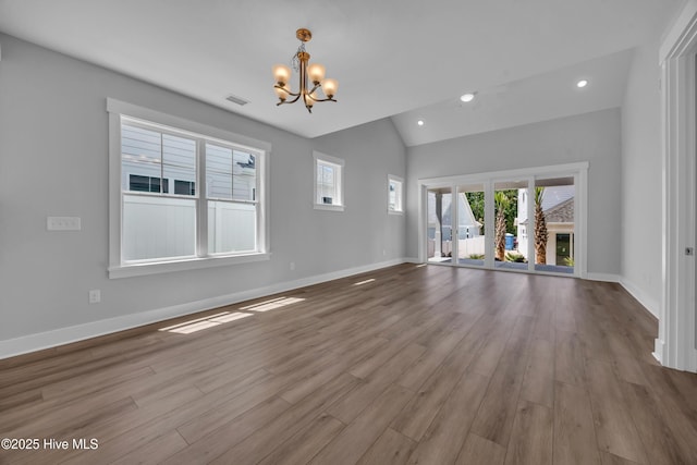1961 Indigo Cove Way, Calabash, NC 28467 - unfurnished living room with a chandelier, lofted ceiling, wood finished floors, baseboards, and recessed lighting