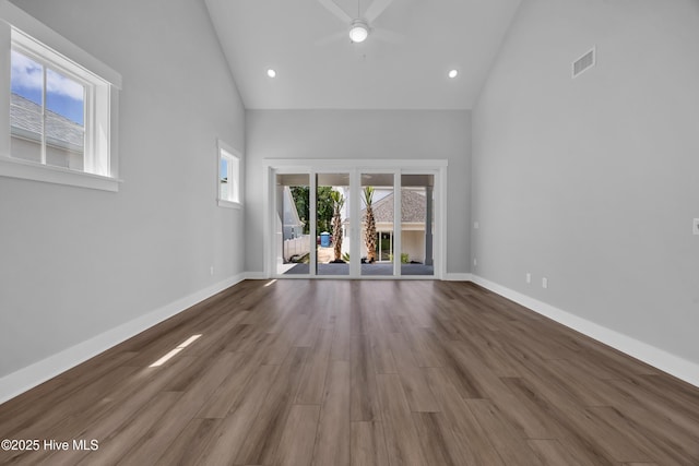 1961 Indigo Cove Way, Calabash, NC 28467 - unfurnished living room featuring high vaulted ceiling, ceiling fan, baseboards, wood finished floors, and recessed lighting