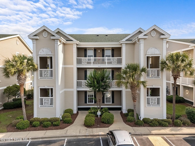 870 Great Egret Cir SW Unit 5F, Sunset Beach, NC 28468 - view of property featuring uncovered parking