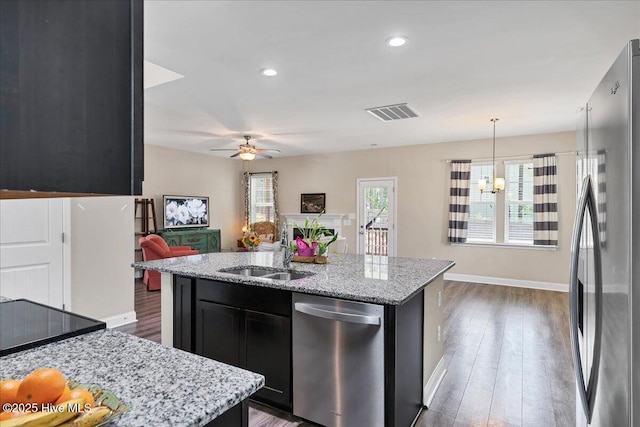 145 Cabin Branch Dr, Carthage, NC 28327 - kitchen featuring appliances with stainless steel finishes, a sink, dark cabinetry, open floor plan, and ceiling fan