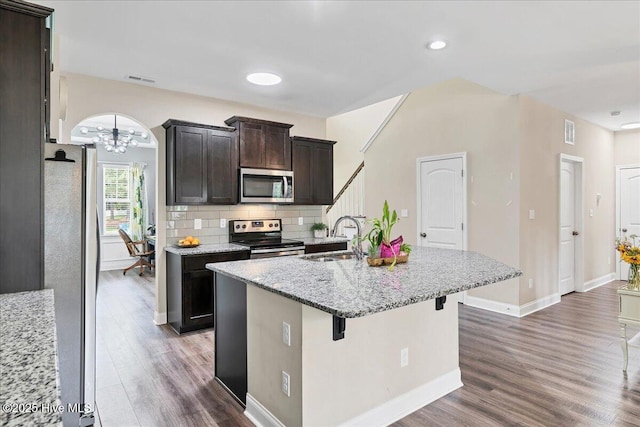 145 Cabin Branch Dr, Carthage, NC 28327 - kitchen with stainless steel appliances, a sink, wood finished floors, an island with sink, and a chandelier